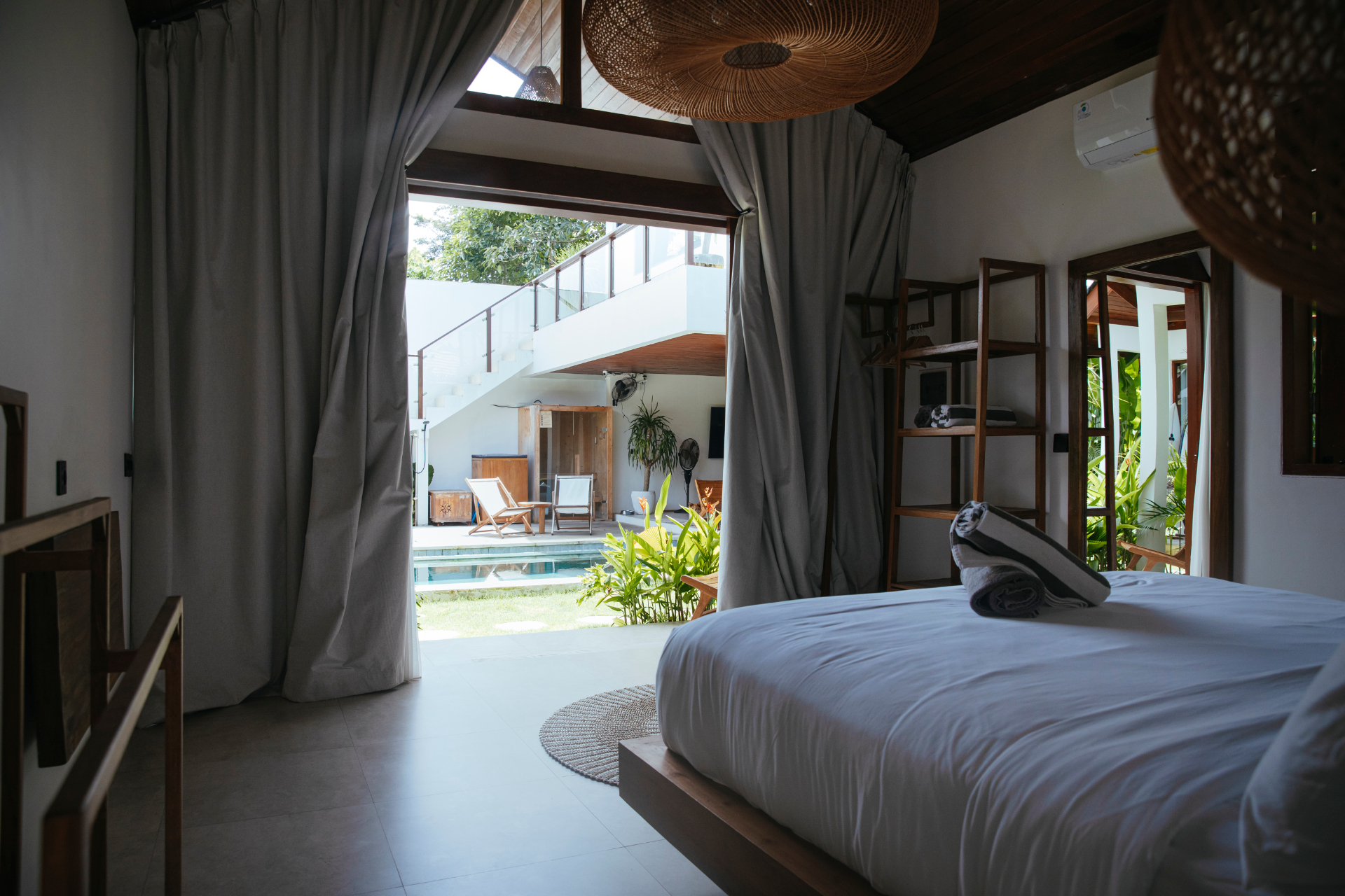 Bedroom opening to shared pool and sauna deck