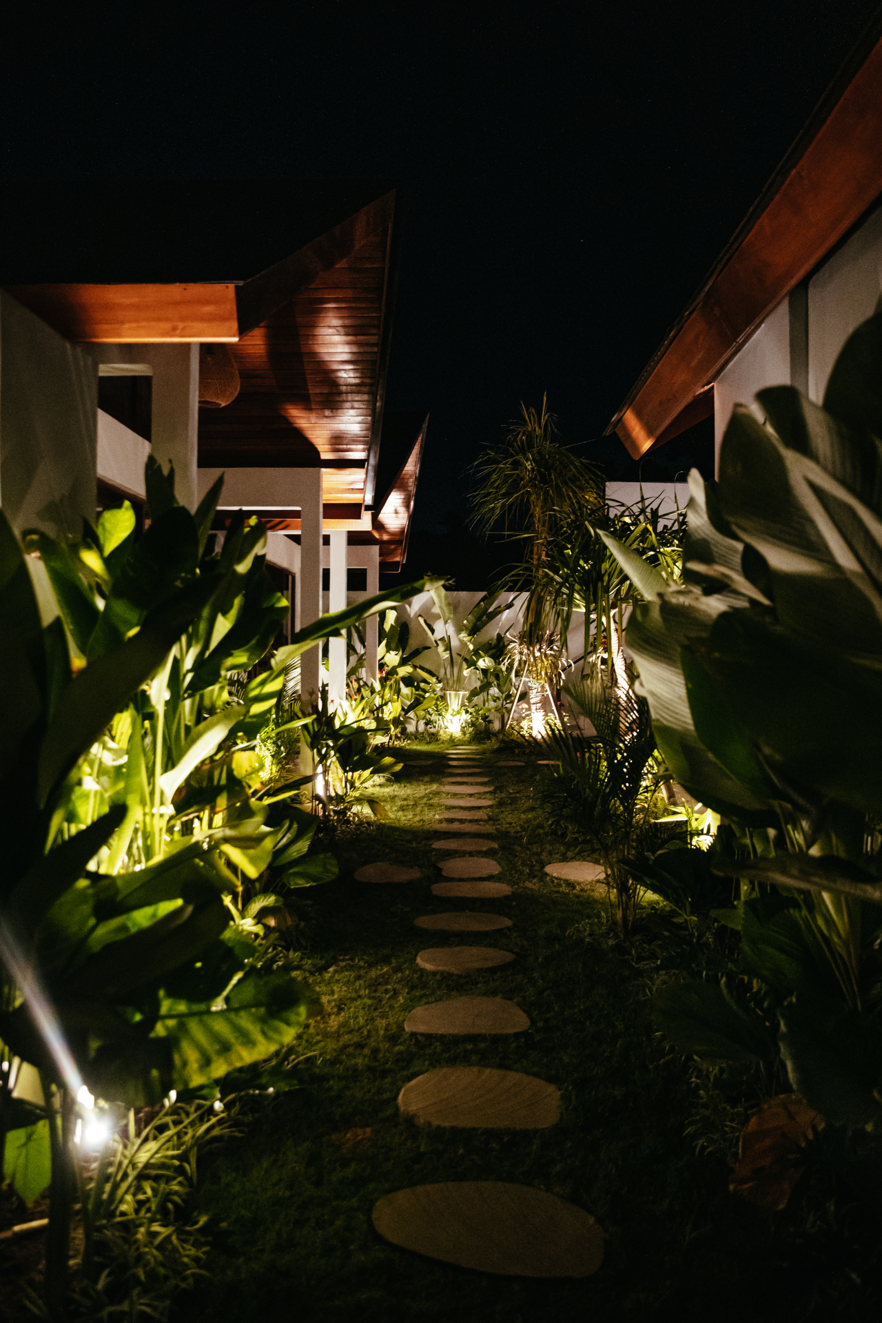 Lit walkway between bungalows